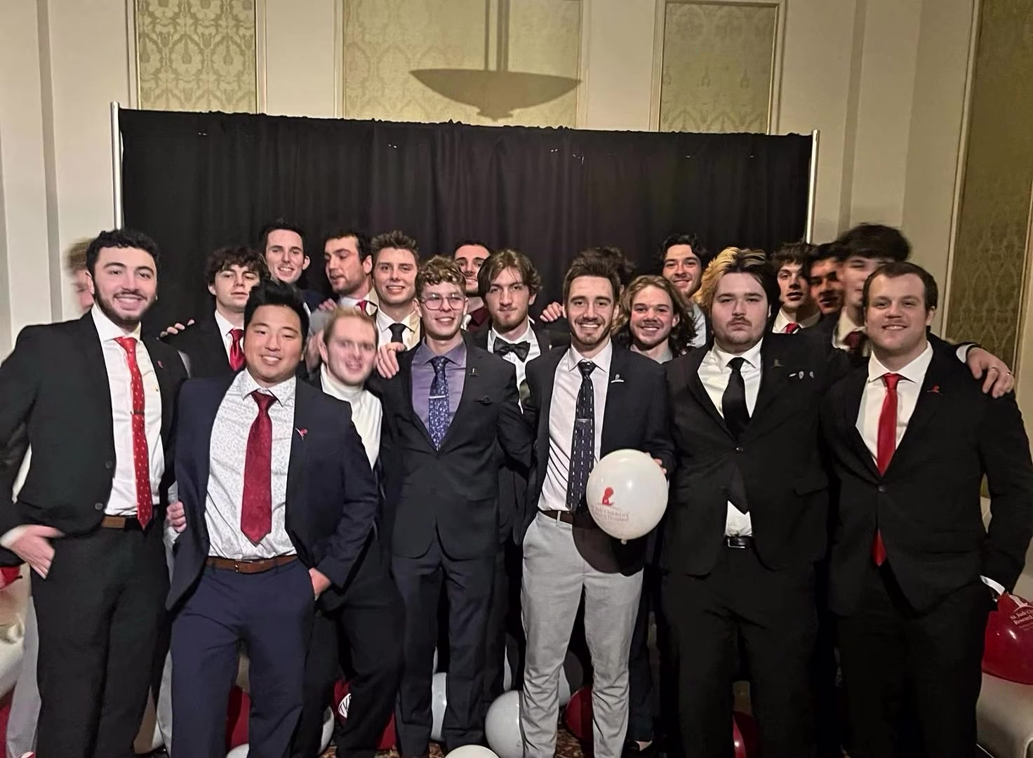 Brothers celebrating with balloons at the gala